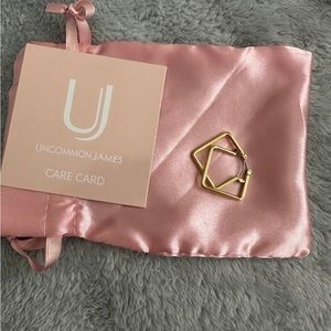 Gently used uncommon James girl boss earrings in gold in a size small